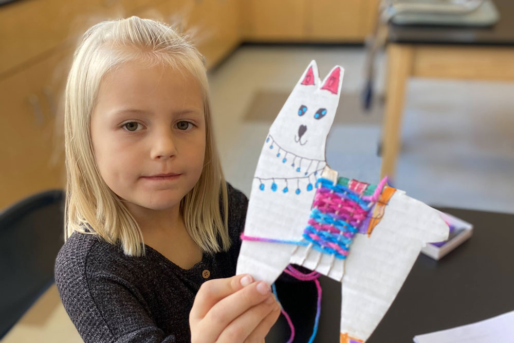 Young girl holding artwork